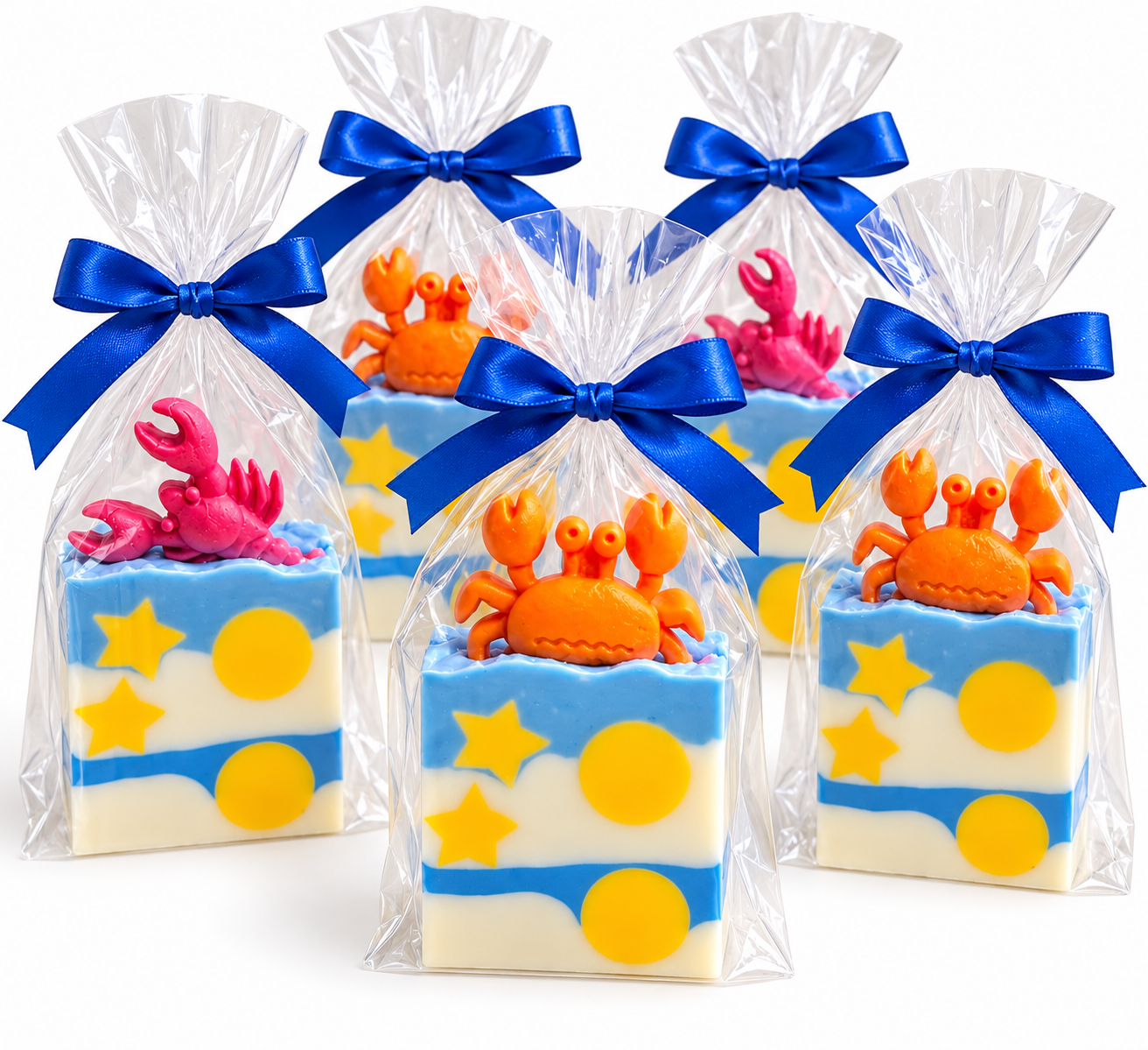 Crab-topped goat milk soap favor bags with blue ribbon ties, yellow stars and circles, and pink and orange crabs