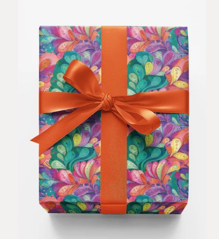 Hand-wrapped gift with peacock paper and ribbon